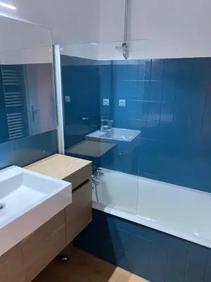 a bathroom with a sink and a tub and a mirror at Location studio plein centre Les Carroz in Les Carroz d'Araches