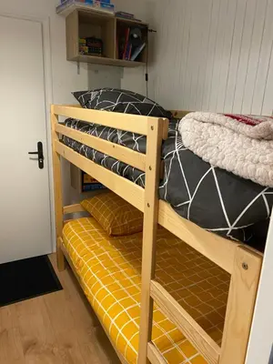 a bunk bed in a room next to a door at Location studio plein centre Les Carroz in Les Carroz d'Araches