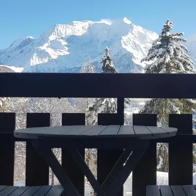 a picnic table with a view of a snow covered mountain at Appartement Saint Gervais les Bains vue imprenable Mont Blanc in Saint-Gervais-les-Bains