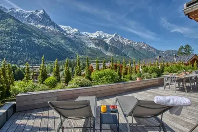 a patio with a view of mountains at Chalet Rytola, modern & central chalet in Chamonix in Chamonix-Mont-Blanc