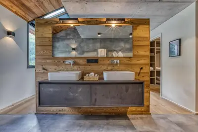 a bathroom with two sinks on a wooden wall at Chalet Rytola, modern & central chalet in Chamonix in Chamonix-Mont-Blanc