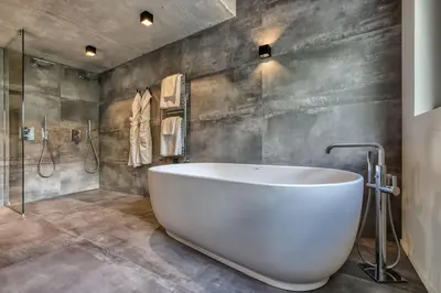 a bathroom with a large white tub and a shower at Chalet Rytola, modern & central chalet in Chamonix in Chamonix-Mont-Blanc