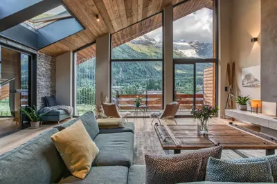 a living room with a couch and a table at Chalet Rytola, modern & central chalet in Chamonix in Chamonix-Mont-Blanc