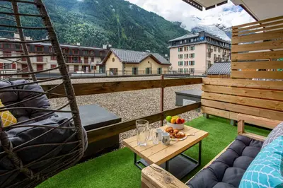 a balcony with a table with fruit on it at Concordia 7 Apartment - Chamonix All Year in Chamonix-Mont-Blanc