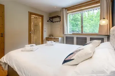 a bedroom with a white bed and a window at Concordia 7 Apartment - Chamonix All Year in Chamonix-Mont-Blanc