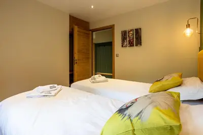 two beds sitting next to each other in a room at Concordia 7 Apartment - Chamonix All Year in Chamonix-Mont-Blanc