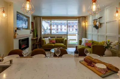 a living room with a table with food on it at Concordia 7 Apartment - Chamonix All Year in Chamonix-Mont-Blanc