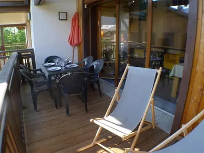 a table and chairs on a balcony with a chalkboard at Duplex Moderne au Centre avec Balcon, 6 Pers. - FR-1-629-13 in Samoëns