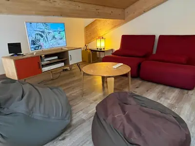 a living room with a red couch and a table at Duplex Moderne au Centre avec Balcon, 6 Pers. - FR-1-629-13 in Samoëns