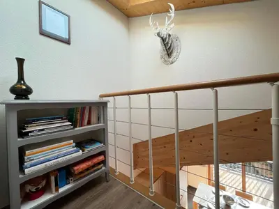 a room with a staircase with a book shelf at Duplex Moderne au Centre avec Balcon, 6 Pers. - FR-1-629-13 in Samoëns