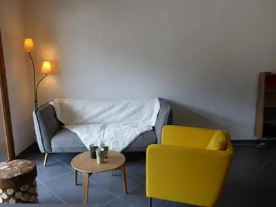 a living room with a couch and a yellow chair at Duplex Moderne au Centre avec Balcon, 6 Pers. - FR-1-629-13 in Samoëns