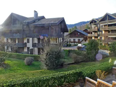 a large house with a yard and a building at Spacieux appartement 4 pièces avec WIFI, animaux acceptés, parking - FR-1-629-14 in Samoëns