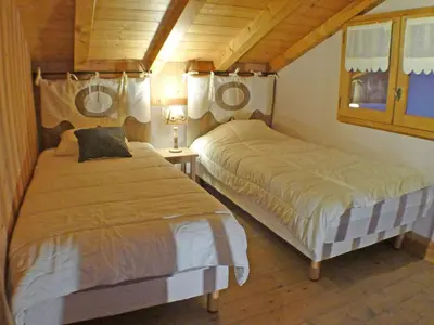 a bedroom with two beds in a room at Chalet spacieux 12 pers, animaux admis, parking, Wi-Fi - FR-1-629-1 in Samoëns