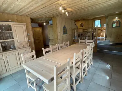 a dining room with a wooden table and chairs at Chalet spacieux 12 pers, animaux admis, parking, Wi-Fi - FR-1-629-1 in Samoëns