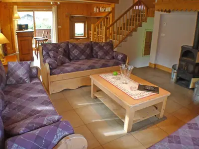 a living room with a couch and a coffee table at Chalet spacieux 12 pers, animaux admis, parking, Wi-Fi - FR-1-629-1 in Samoëns