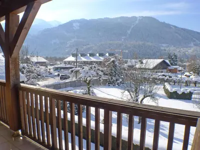 a balcony with a view of a snow covered mountain at Appartement spacieux 3 pièces avec balcon et garage à Samoëns - FR-1-629-17 in Samoëns