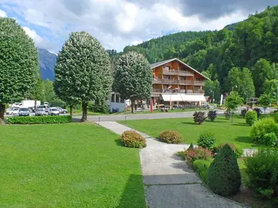 a house in the middle of a park with a walkway at Grand T3 avec cabine - 6 à 8 pers. - Samoëns - FR-1-629-4 in Samoëns