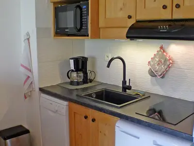 a kitchen with a sink and a microwave at Appartement de 6 personnes avec terrasse, parking et Wi-Fi - FR-1-629-25 in Samoëns