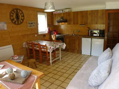 a kitchen with a table and a counter top at T2 calme à Samoëns, terrasse et parking pour 4-6 pers. - FR-1-629-16 in Samoëns