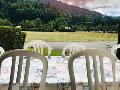 a table and chairs with a view of a field at T2 calme à Samoëns, terrasse et parking pour 4-6 pers. - FR-1-629-16 in Samoëns