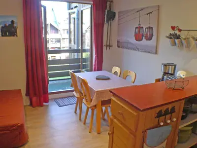 a kitchen and dining room with a table and a window at Appartement 5 pers. avec balcon privé et parking à Samoëns - FR-1-629-20 in Samoëns