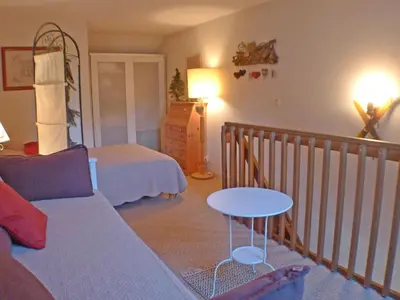 a bedroom with a bed and a table and a couch at Appartement 5 pers. avec balcon privé et parking à Samoëns - FR-1-629-20 in Samoëns