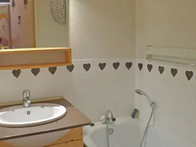 a bathroom with a sink and a toilet and a mirror at Appartement 5 pers. avec balcon privé et parking à Samoëns - FR-1-629-20 in Samoëns