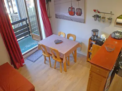 a dining room with a table and chairs and a window at Appartement 5 pers. avec balcon privé et parking à Samoëns - FR-1-629-20 in Samoëns