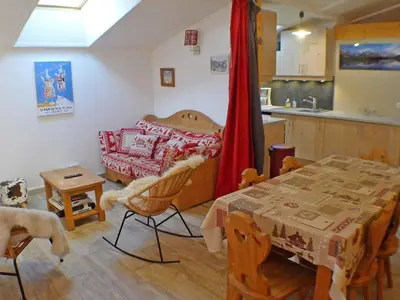 a kitchen and a dining room with a table and a table and a dining room at Coquet 3 pièces lumineux, centre de Samoëns, animaux acceptés, wifi, parking - FR-1-629-23 in Samoëns
