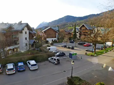 a small town with cars parked in a parking lot at Coquet 3 pièces lumineux, centre de Samoëns, animaux acceptés, wifi, parking - FR-1-629-23 in Samoëns