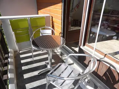 a patio with a table and chairs on a porch at Coquet 3 pièces lumineux, centre de Samoëns, animaux acceptés, wifi, parking - FR-1-629-23 in Samoëns