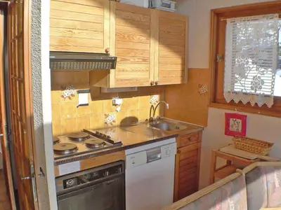 a small kitchen with a stove and a sink at Appartement calme à Samoëns, 2 chambres, animaux admis, proche centre - FR-1-629-24 in Samoëns