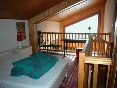 a bedroom with a bed and a balcony at Appartement calme à Samoëns, 2 chambres, animaux admis, proche centre - FR-1-629-24 in Samoëns