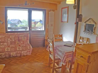 a dining room with a table and chairs and a window at Charmant duplex pour 6 pers. avec TV et parking à Samoëns. - FR-1-629-29 in Samoëns