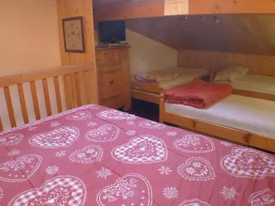 a bedroom with two bunk beds with a red and white blanket at Charmant duplex pour 6 pers. avec TV et parking à Samoëns. - FR-1-629-29 in Samoëns