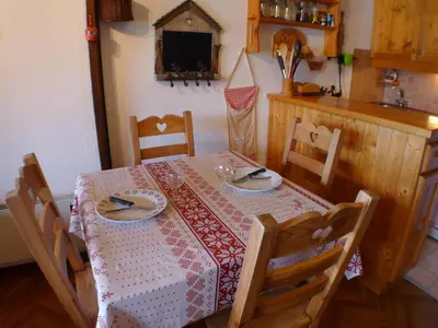 a dining room table with a red and white table cloth at Charmant duplex pour 6 pers. avec TV et parking à Samoëns. - FR-1-629-29 in Samoëns