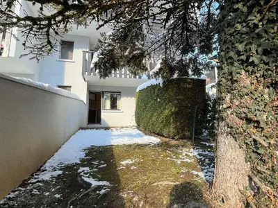 a house with snow on the ground next to a tree at Coquet studio RDC avec terrasse, animaux admis, étang Samoëns - FR-1-629-55 in Samoëns
