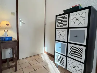a black and white dresser in a room with a table at Coquet studio RDC avec terrasse, animaux admis, étang Samoëns - FR-1-629-55 in Samoëns