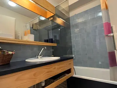 a bathroom with a sink and a tub at Coquet studio RDC avec terrasse, animaux admis, étang Samoëns - FR-1-629-55 in Samoëns