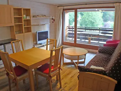 a kitchen and living room with a table and chairs at Grand studio à Samoëns, animaux admis, parking, proche télécabine - FR-1-629-54 in Samoëns