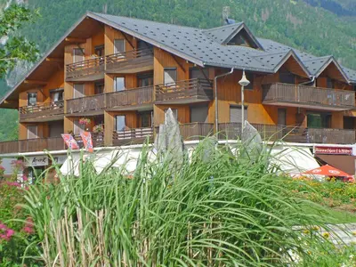 a large wooden building with balconies on it at Grand studio à Samoëns, animaux admis, parking, proche télécabine - FR-1-629-54 in Samoëns