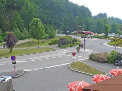 an empty street with red umbrellas in a town at Grand studio à Samoëns, animaux admis, parking, proche télécabine - FR-1-629-54 in Samoëns