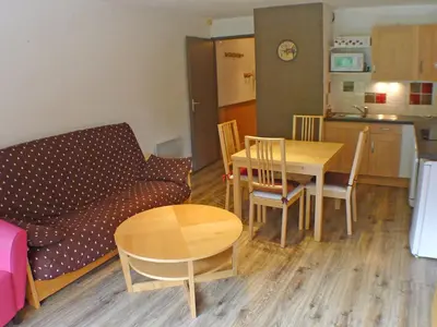a living room with a couch and a table at Grand studio à Samoëns, animaux admis, parking, proche télécabine - FR-1-629-54 in Samoëns