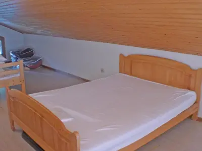 a bed in a room with a wooden ceiling at Appartement charme 5 pers., balcon, parking sous-sol - FR-1-629-38 in Samoëns