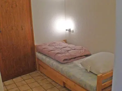 a small room with a bed and a door at Appartement charme 5 pers., balcon, parking sous-sol - FR-1-629-38 in Samoëns