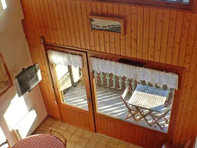 a room with a porch with a bench and windows at Appartement charme 5 pers., balcon, parking sous-sol - FR-1-629-38 in Samoëns