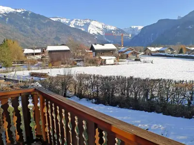 a winter view of a town with snow covered mountains at Appartement charme 5 pers., balcon, parking sous-sol - FR-1-629-38 in Samoëns