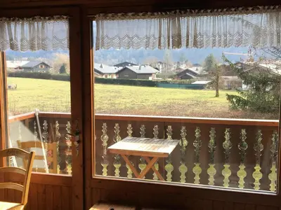 a table on a balcony with a view of a field at Appartement charme 5 pers., balcon, parking sous-sol - FR-1-629-38 in Samoëns