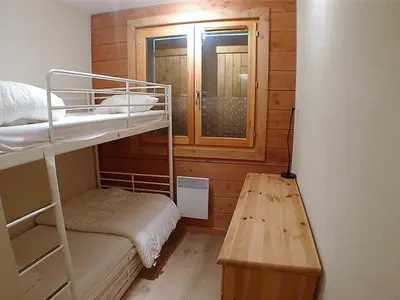 a small room with a bunk bed and a window at 3 pièces calme à Samoëns avec parking privé, 4 couchages - FR-1-629-48 in Samoëns