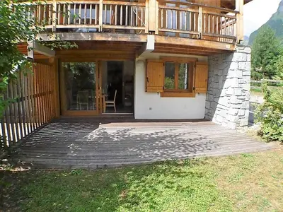 a house with a wooden deck and a balcony at 3 pièces calme à Samoëns avec parking privé, 4 couchages - FR-1-629-48 in Samoëns